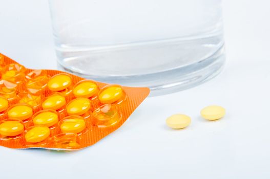 An image of headache pills and glass of water