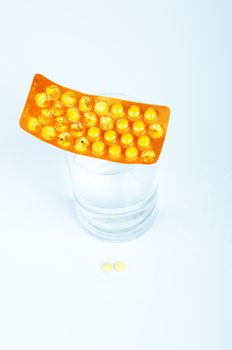 An image of headache pills and glass of water