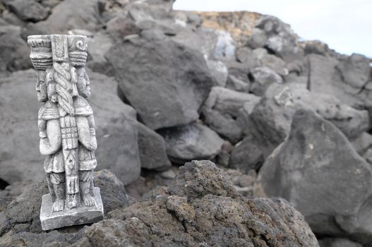 Ancient Maya Statue on the Rocks near the Ocean