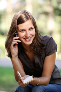 Young beautiful woman talking on cell phone