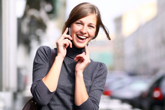 Young beautiful woman talking on cell phone