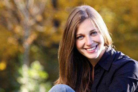 Beautiful young woman in autumn park