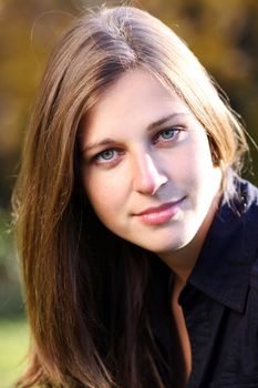 Beautiful young woman in autumn park