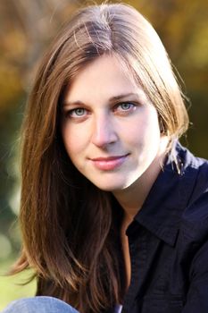 Beautiful young woman in autumn park
