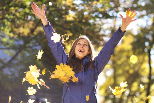 Beautiful young woman in autumn park