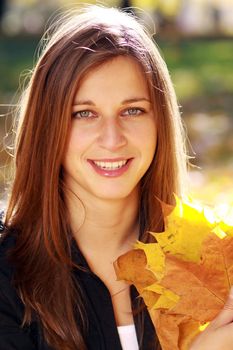 Beautiful young woman in autumn park