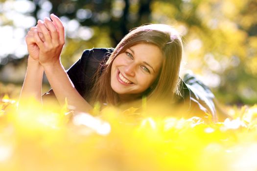 Beautiful young woman in autumn park