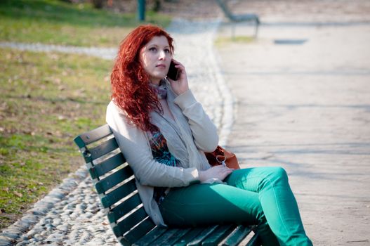 beautiful young woman on the phone in the park