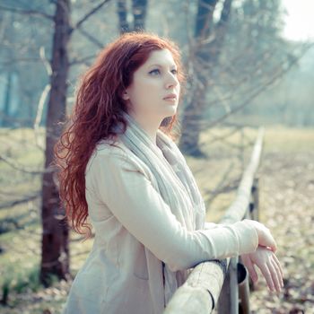 beautiful young woman posing in the park of the city