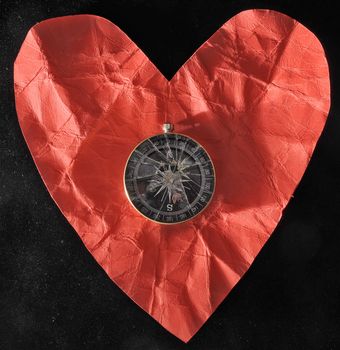 Orientation in Love - Red Paper Heart and Compass on a black Background