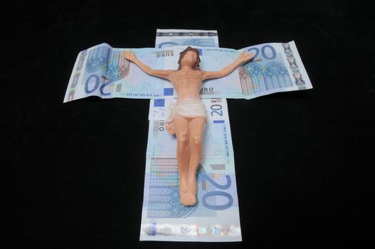 Jesus Christ and Money on a Dark Background - Religion Concept