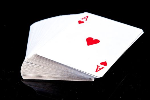 An image of playing cards, dice and money