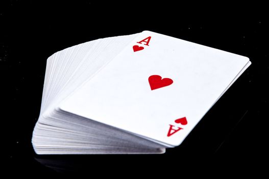 An image of playing cards, dice and money
