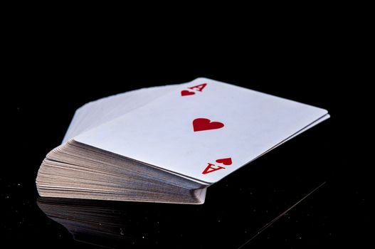 An image of playing cards, dice and money