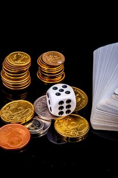 An image of playing cards, dice and money