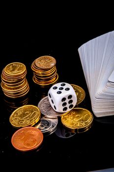 An image of playing cards, dice and money