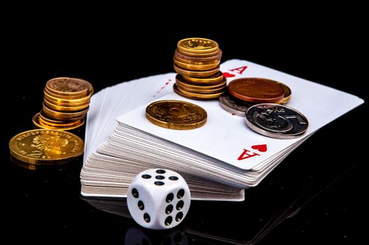 An image of playing cards, dice and money