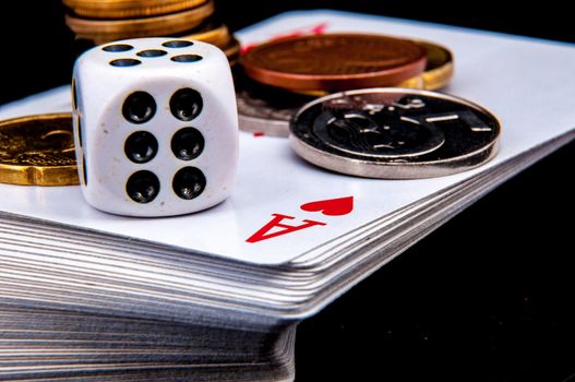 An image of playing cards, dice and money