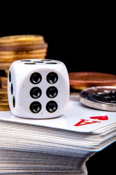 An image of playing cards, dice and money