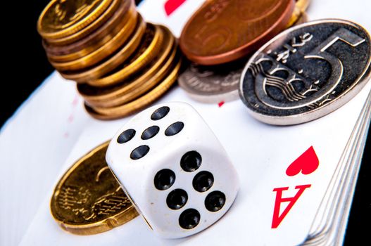 An image of playing cards, dice and money