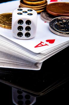 An image of playing cards, dice and money