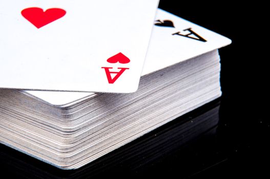 An image of playing cards, dice and money