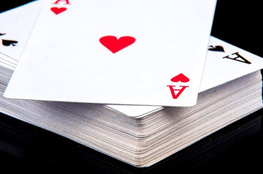 An image of playing cards, dice and money