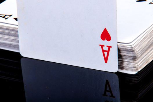 An image of playing cards, dice and money