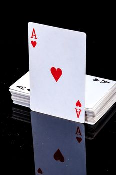 An image of playing cards, dice and money