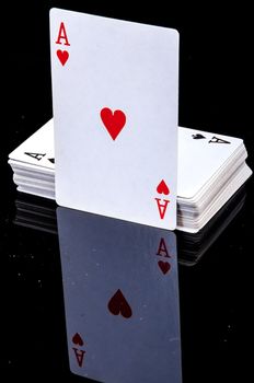 An image of playing cards, dice and money
