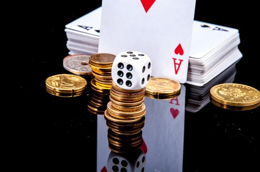 An image of playing cards, dice and money