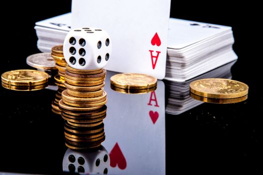An image of playing cards, dice and money