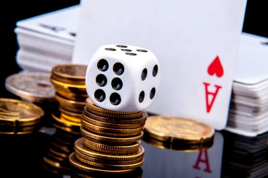 An image of playing cards, dice and money