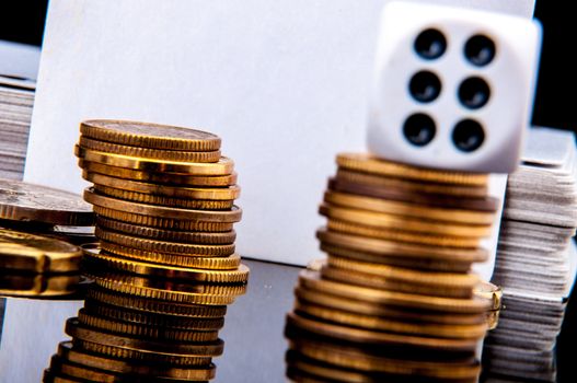 An image of playing cards, dice and money