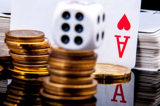 An image of playing cards, dice and money