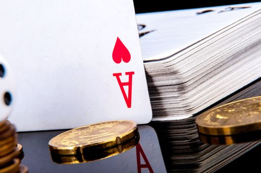 An image of playing cards, dice and money