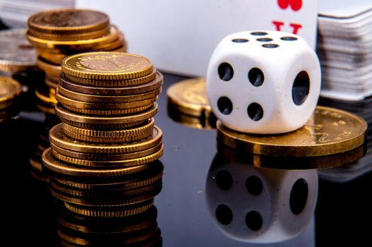 An image of playing cards, dice and money