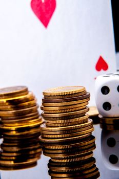 An image of playing cards, dice and money