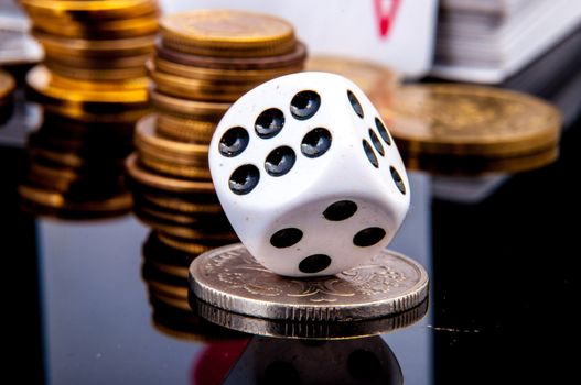An image of playing cards, dice and money