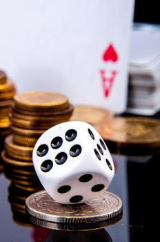 An image of playing cards, dice and money