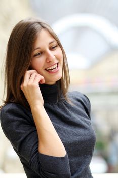 Young beautiful woman talking on cell phone