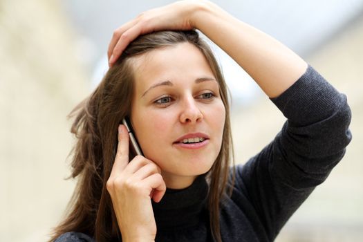 Young beautiful woman talking on cell phone