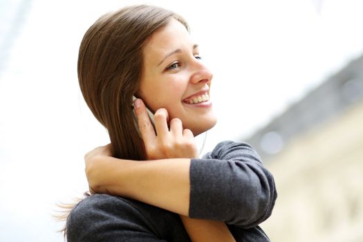 Young beautiful woman talking on cell phone