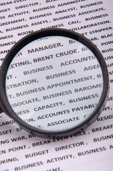 An image of magnify glass over paper with written business slang