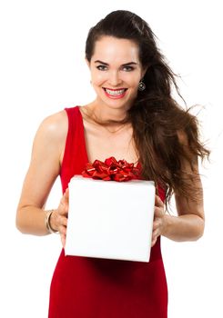 A beautiful happy woman holding a gift. Isolated on white.
