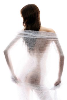 The body of a beautiful naked woman through the transparent fabric on a white background