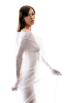 The body of a beautiful naked woman through the transparent fabric on a white background