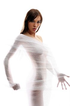 The body of a beautiful naked woman through the transparent fabric on a white background