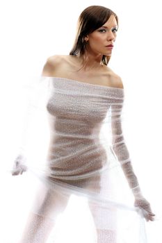The body of a beautiful naked woman through the transparent fabric on a white background