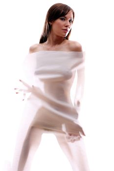 The body of a beautiful naked woman through the transparent fabric on a white background